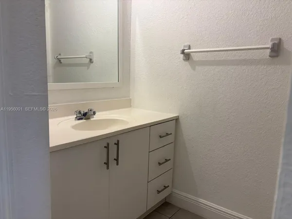 a bathroom with a sink and mirror