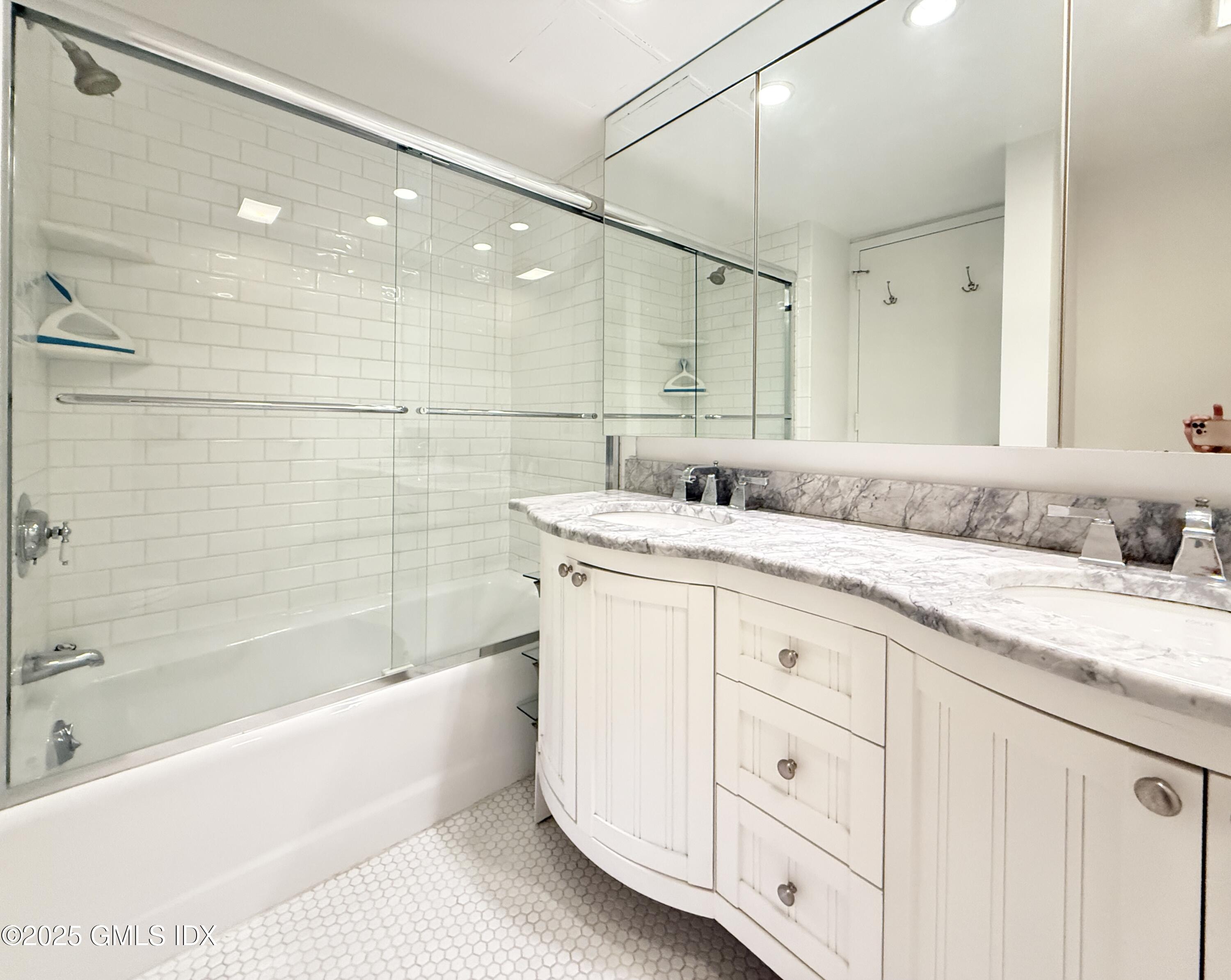 25 Forest Street, Unit 11M Stamford, CT 06901 - Photo 12 of 21 a bathroom with a granite countertop sink mirror and a