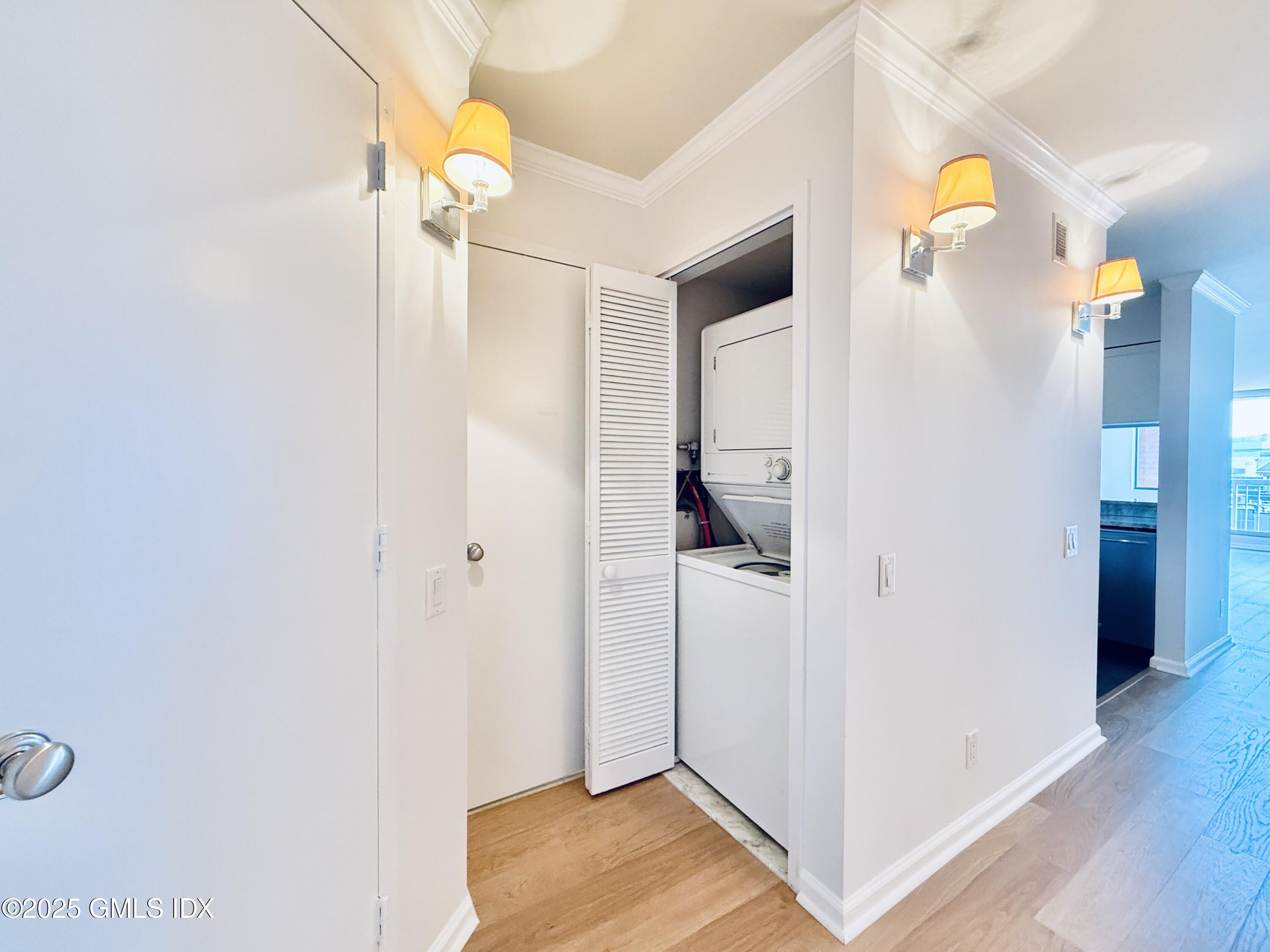 25 Forest Street, Unit 11M Stamford, CT 06901 - Photo 13 of 21 a bedroom with a bed and a chandelier