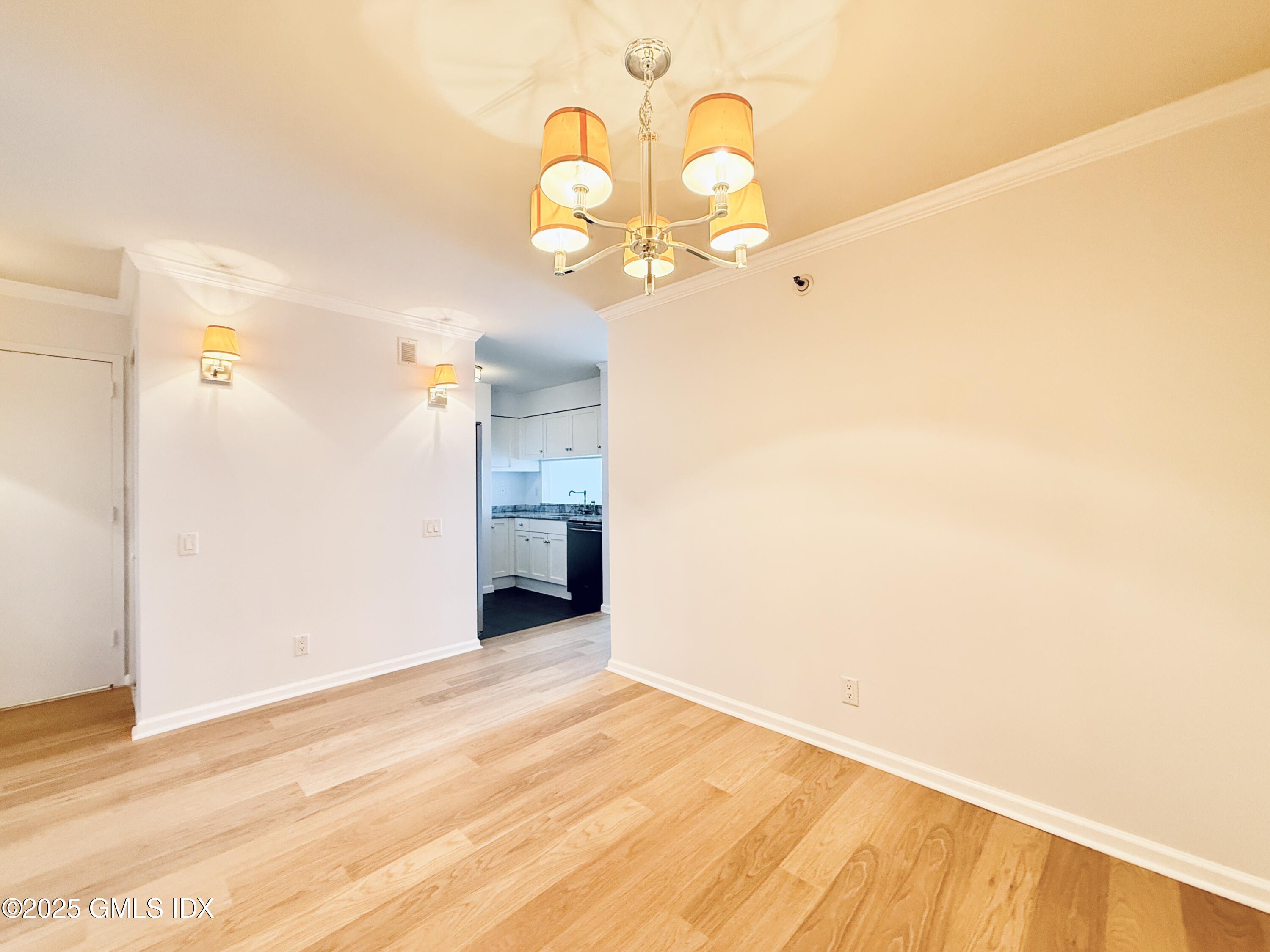 25 Forest Street, Unit 11M Stamford, CT 06901 - Photo 8 of 21 a view of a room with wooden floor and white wall