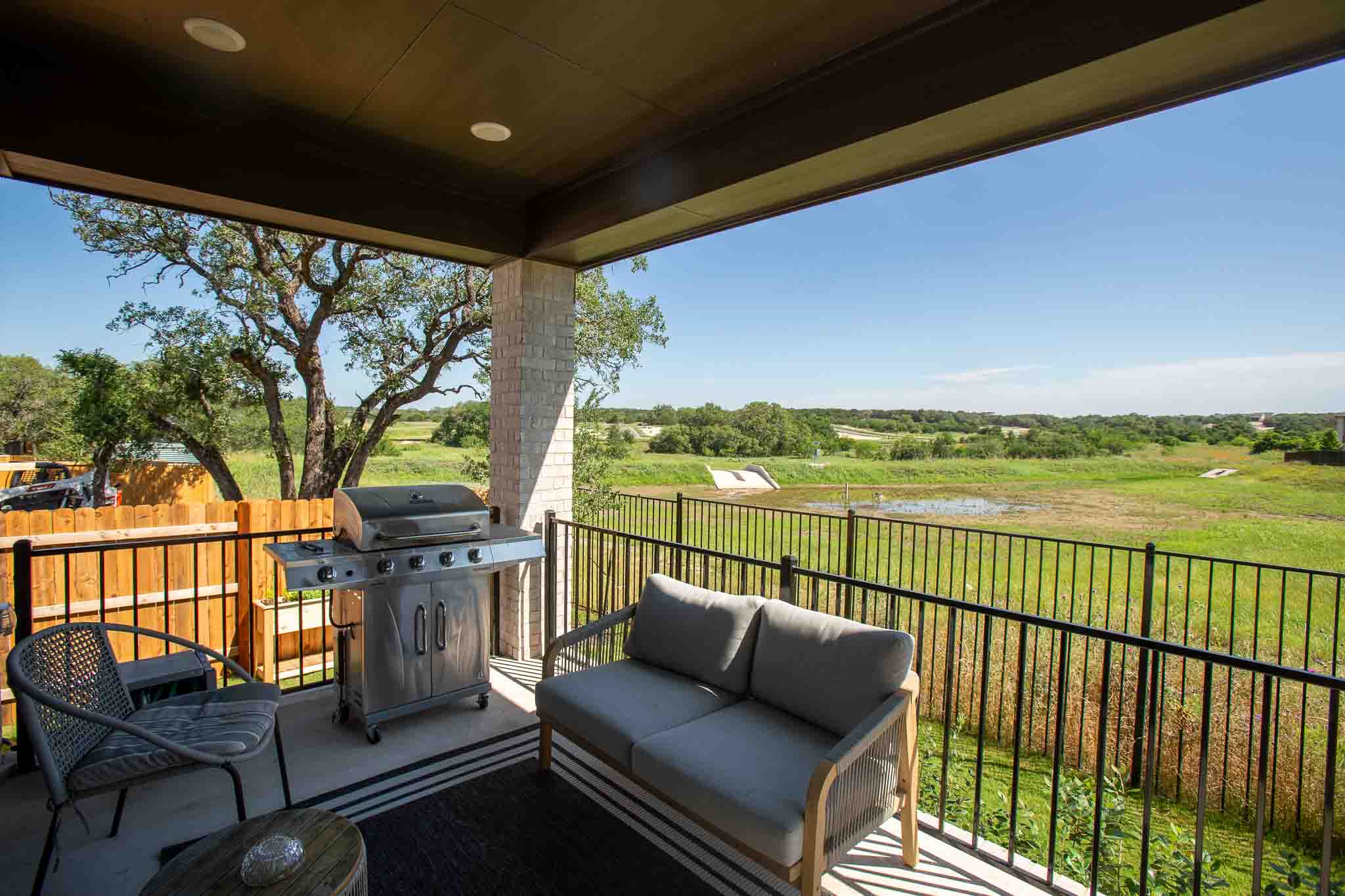 220 Basket Flower Loop Kyle, TX 78640 - Photo 33 of 40 A tranquil covered patio offers an elevated view of the sprawling natural landscape.