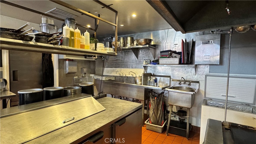 35 East Commercial Street Willits, CA 95490 - Photo 11 of 19 a kitchen with stainless steel appliances granite countertop a sink and cabinets