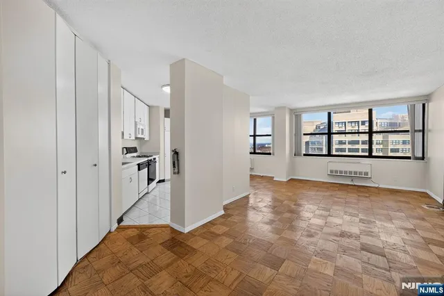 a view of a big room with windows and refrigerator