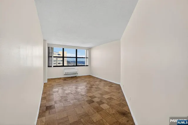 a kitchen with white cabinets and appliances