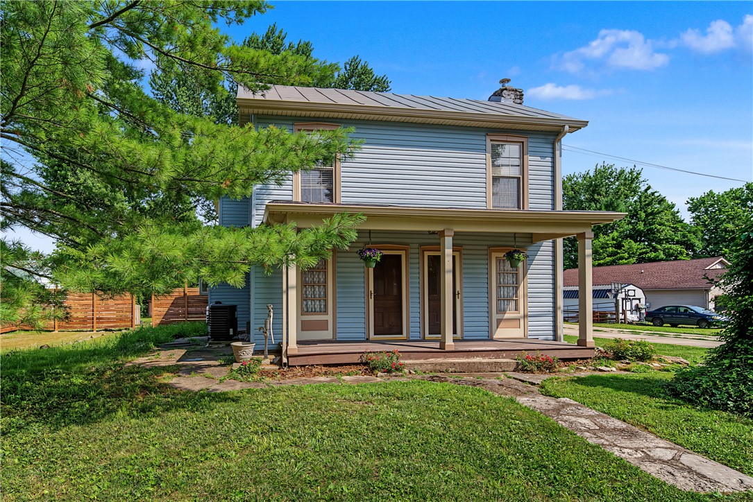 8707 Lytle Ferry Road Waynesville, OH 45068 - Photo 2 of 54 A charming two-story residence with a welcoming front porch set against a clear blue sky.