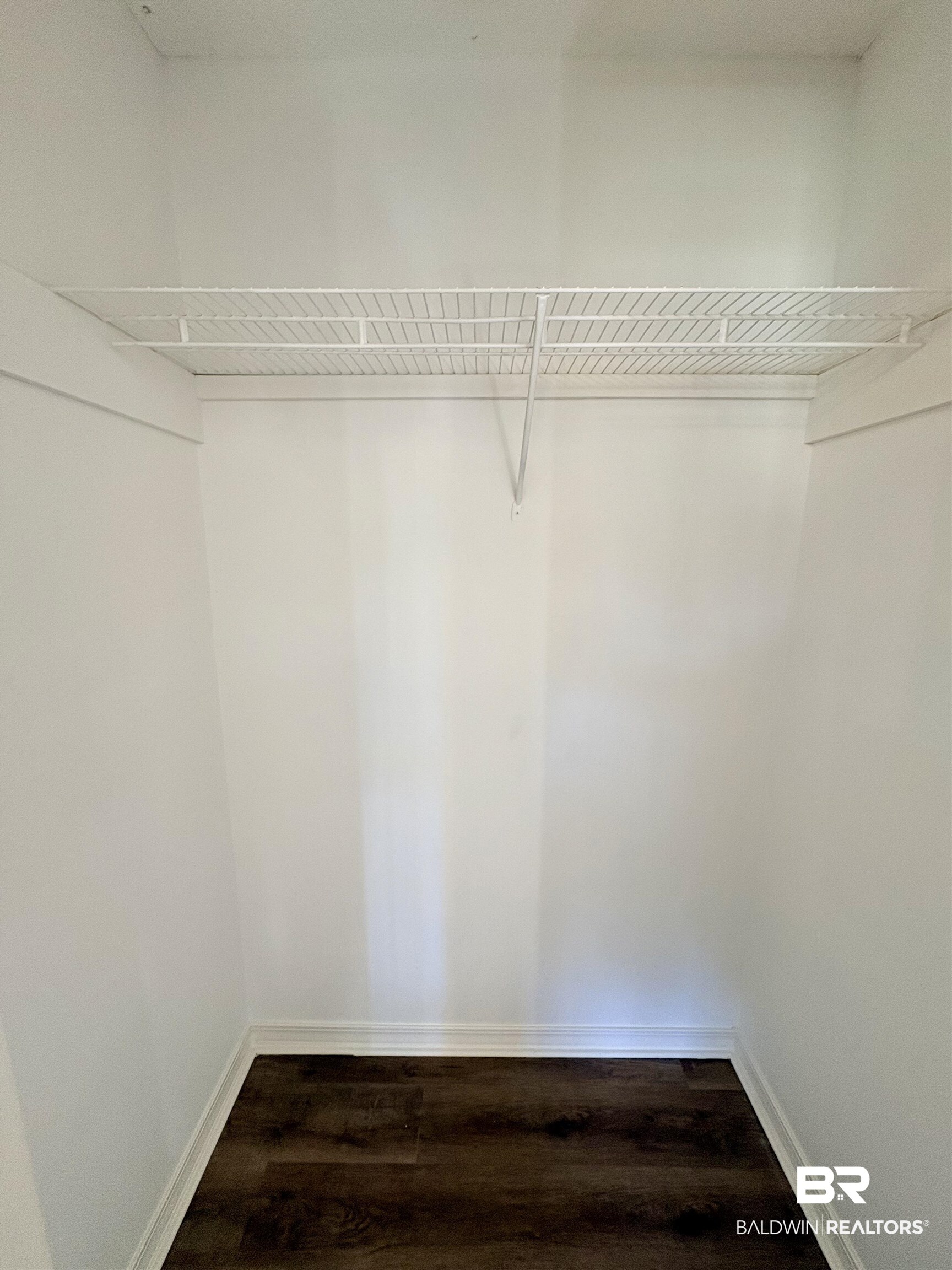 47 Fairview Street Evergreen, AL 36401 - Photo 11 of 15 Walk in closet featuring dark wood-style flooring