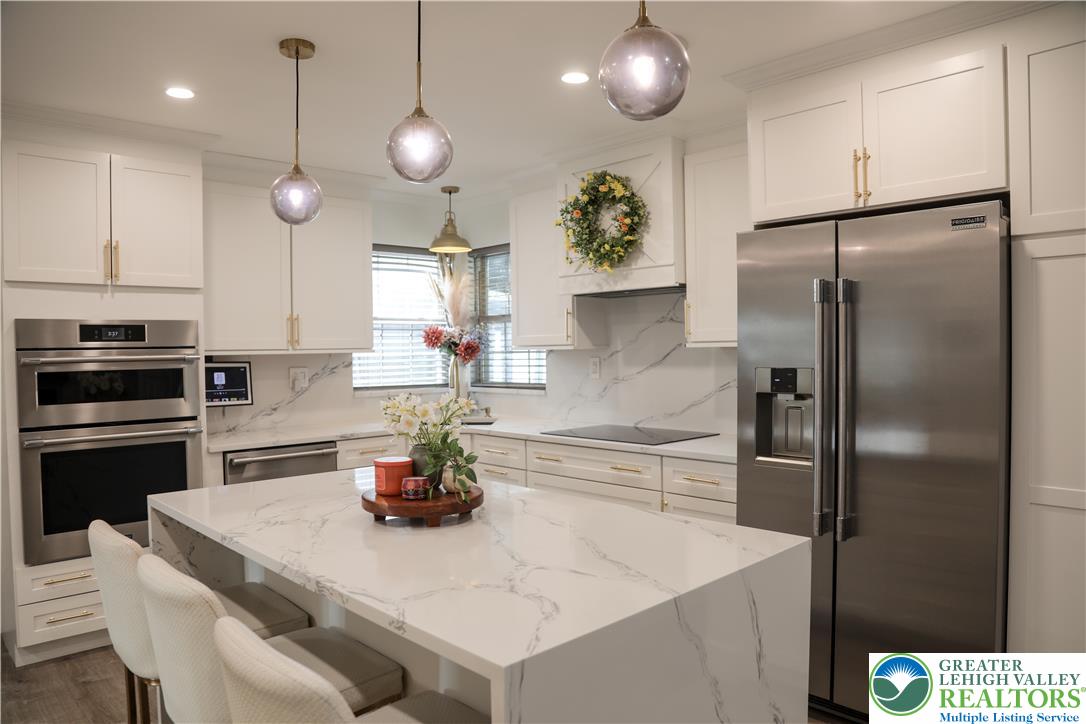 1412 Stanford Road Bethlehem, PA 18018 - Photo 18 of 58 A pristine culinary space features an inviting kitchen island and integrated stainless steel appliances.