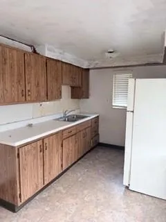 a kitchen with a sink a stove and cabinets