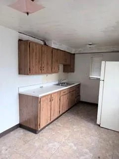 a kitchen with stainless steel appliances a refrigerator a sink a stove a microwave and cabinets