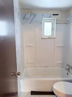 a bathroom with a bathtub and a shower