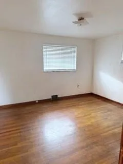 a view of an empty room and wooden floor