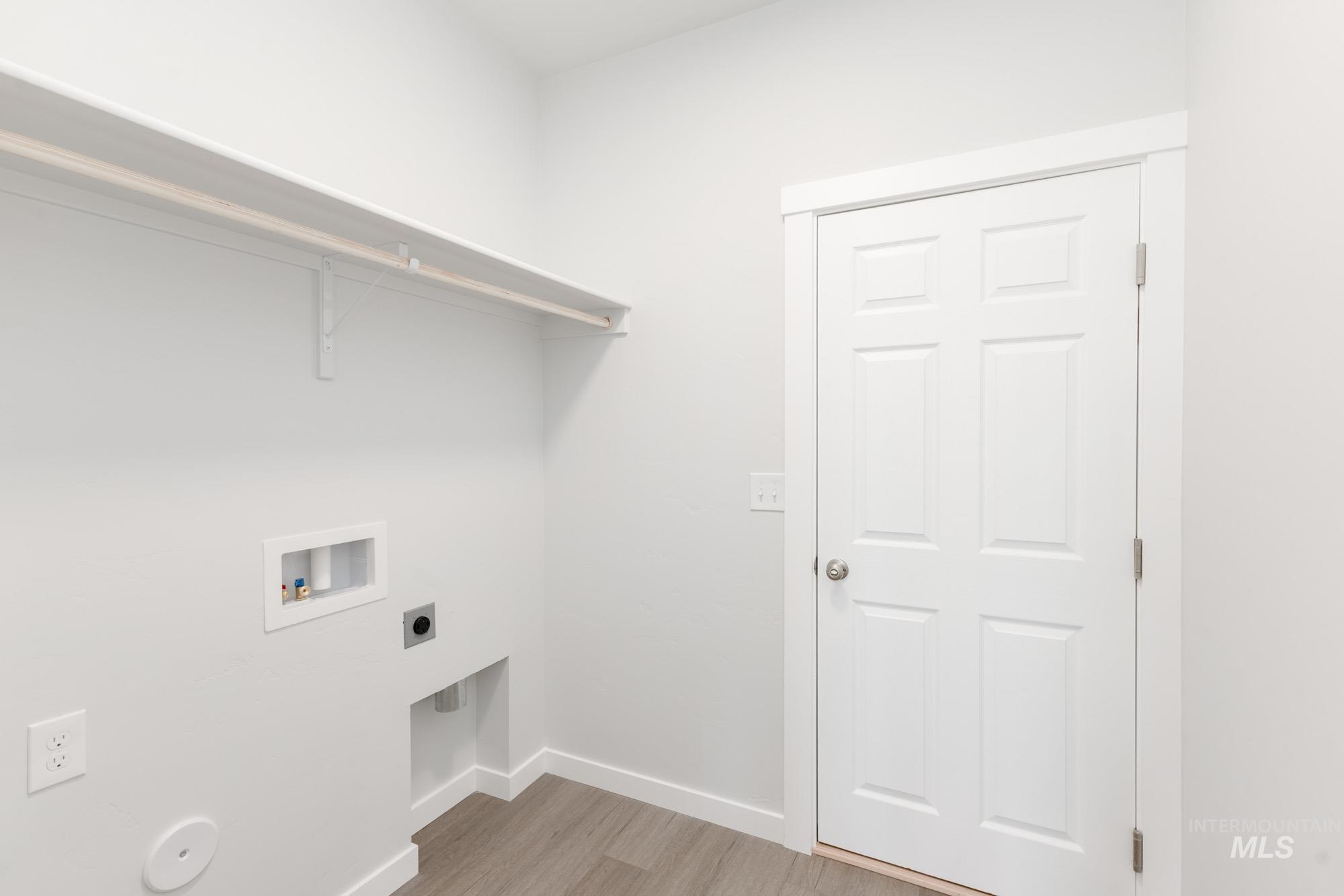 13678 Nisene Street Caldwell, ID 83607 - Photo 12 of 19 Laundry area with light wood-style flooring, washer hookup, and hookup for an electric dryer