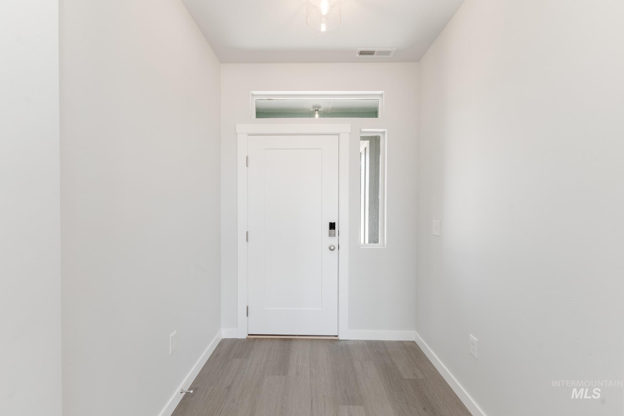 13678 Nisene Street Caldwell, ID 83607 - Photo 2 of 19 Foyer entrance featuring baseboards and light wood finished floors