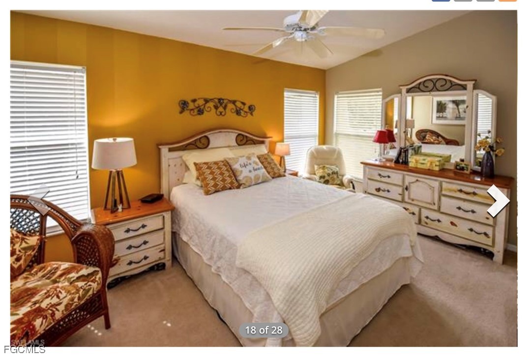 14971 Rivers Edge Court, Unit 201 Fort Myers, FL 33908 - Photo 5 of 8 a bedroom with a bed and a flat tv screen on dresser