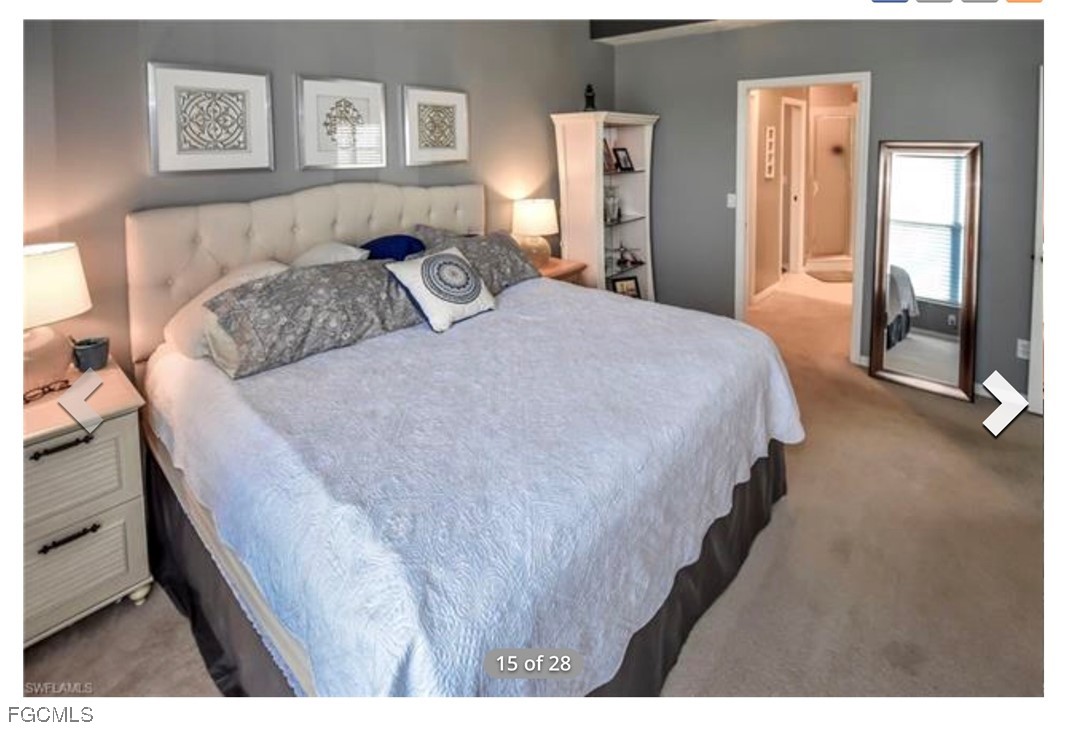 14971 Rivers Edge Court, Unit 201 Fort Myers, FL 33908 - Photo 6 of 8 a bedroom with a bed and painting on the wall