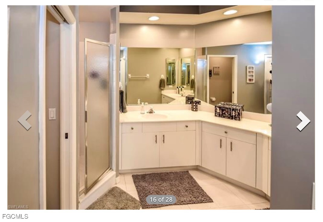 14971 Rivers Edge Court, Unit 201 Fort Myers, FL 33908 - Photo 7 of 8 a bathroom with a sink a toilet a mirror and shower