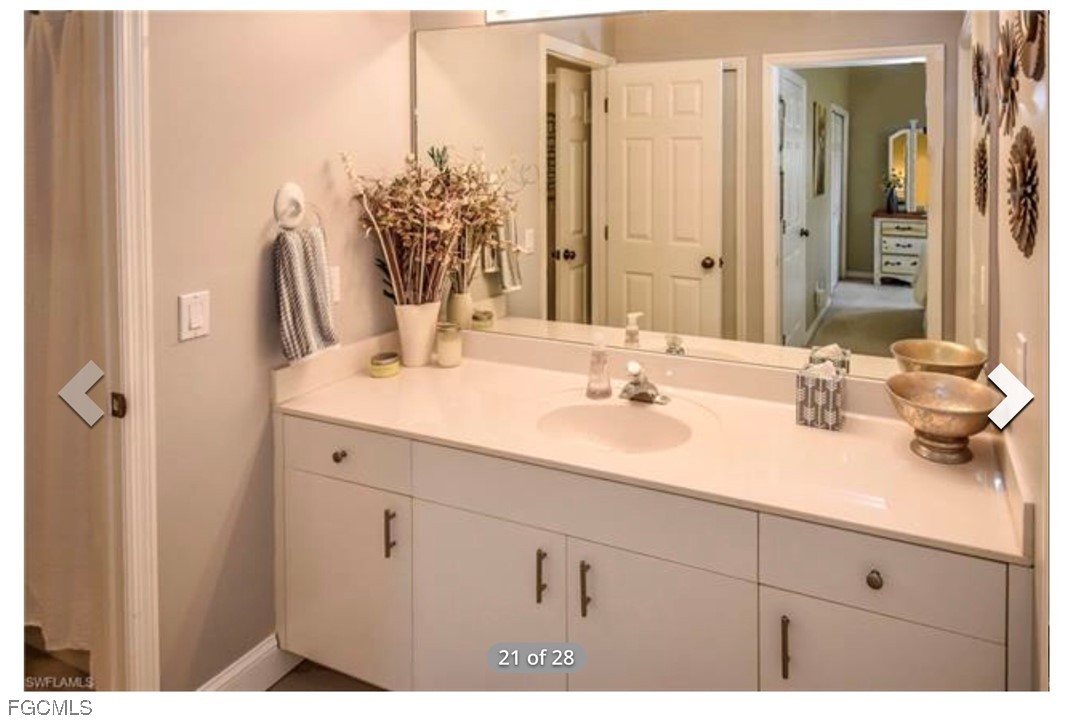 14971 Rivers Edge Court, Unit 201 Fort Myers, FL 33908 - Photo 8 of 8 a bathroom with a sink double vanity granite and a mirror