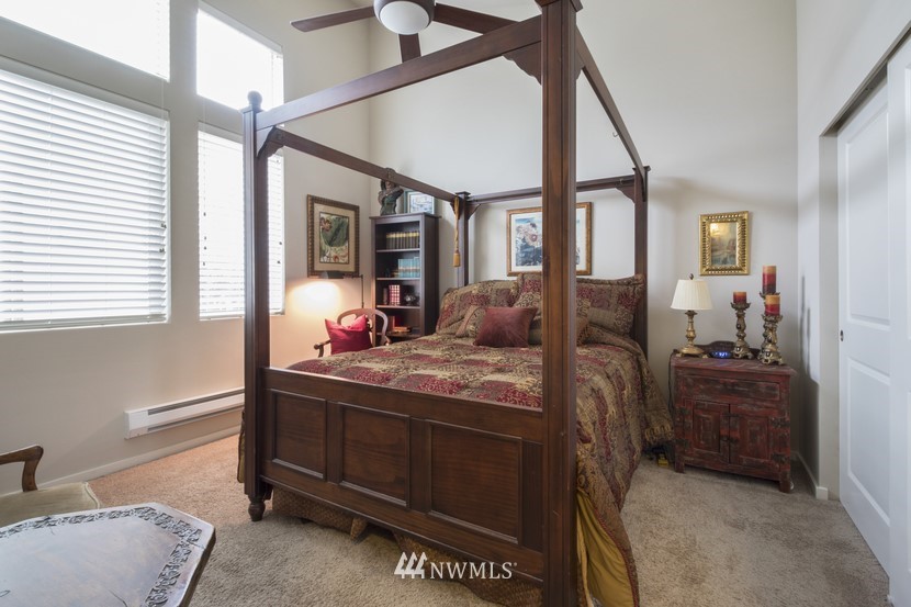 4520 Northeast 3rd Lane Renton, WA 98059 - Photo 14 of 20 a bedroom with a bed and large windows