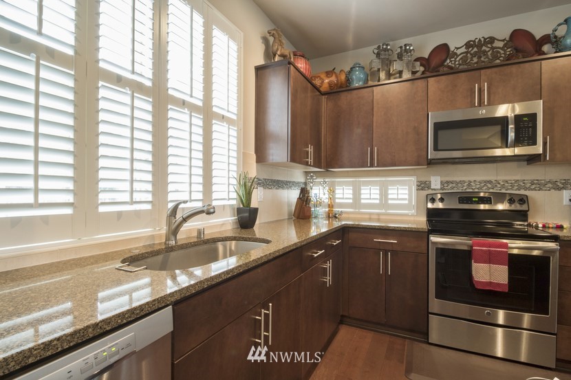 4520 Northeast 3rd Lane Renton, WA 98059 - Photo 9 of 20 a kitchen with stainless steel appliances a stove a sink and a microwave