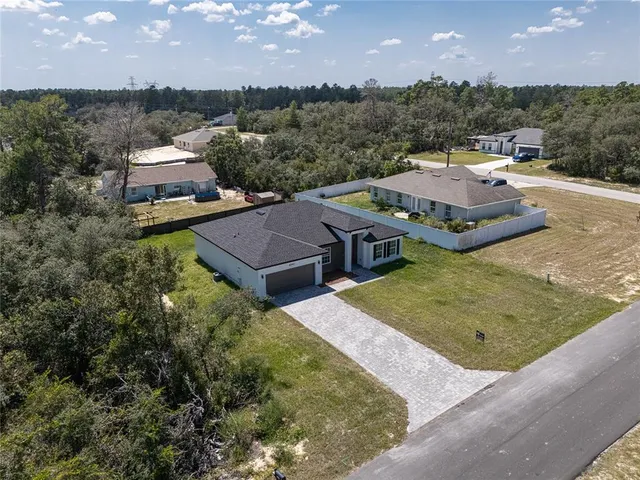 an aerial view of a house with yard swimming pool and outdoor seating