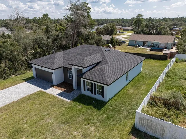 an aerial view of a house having yard patio and lake view