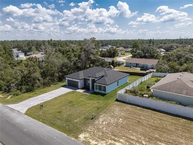 a view of a house with a yard and sitting area