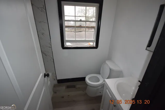a white toilet sitting next to a window