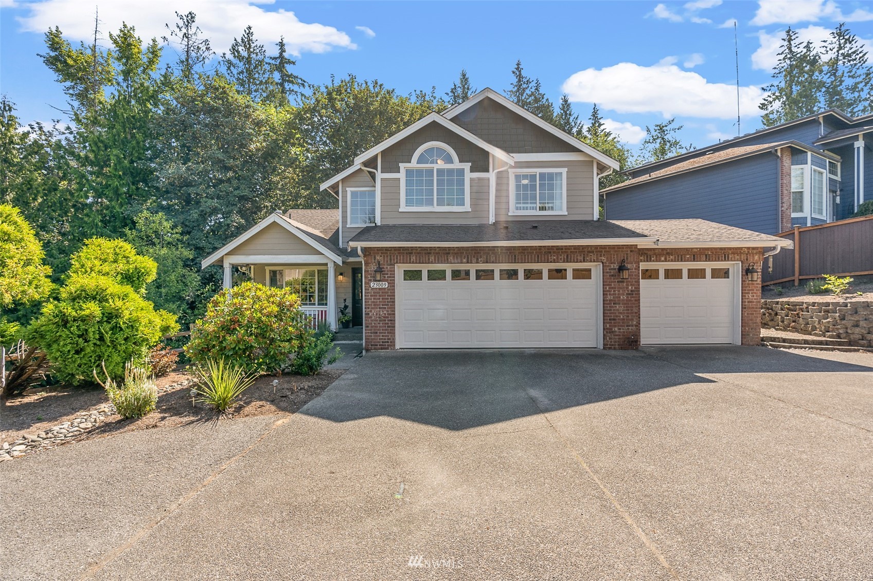 23009 21st Avenue Southeast Bothell, WA 98021 - Photo 4 of 40 a front view of a house with a garden and yard