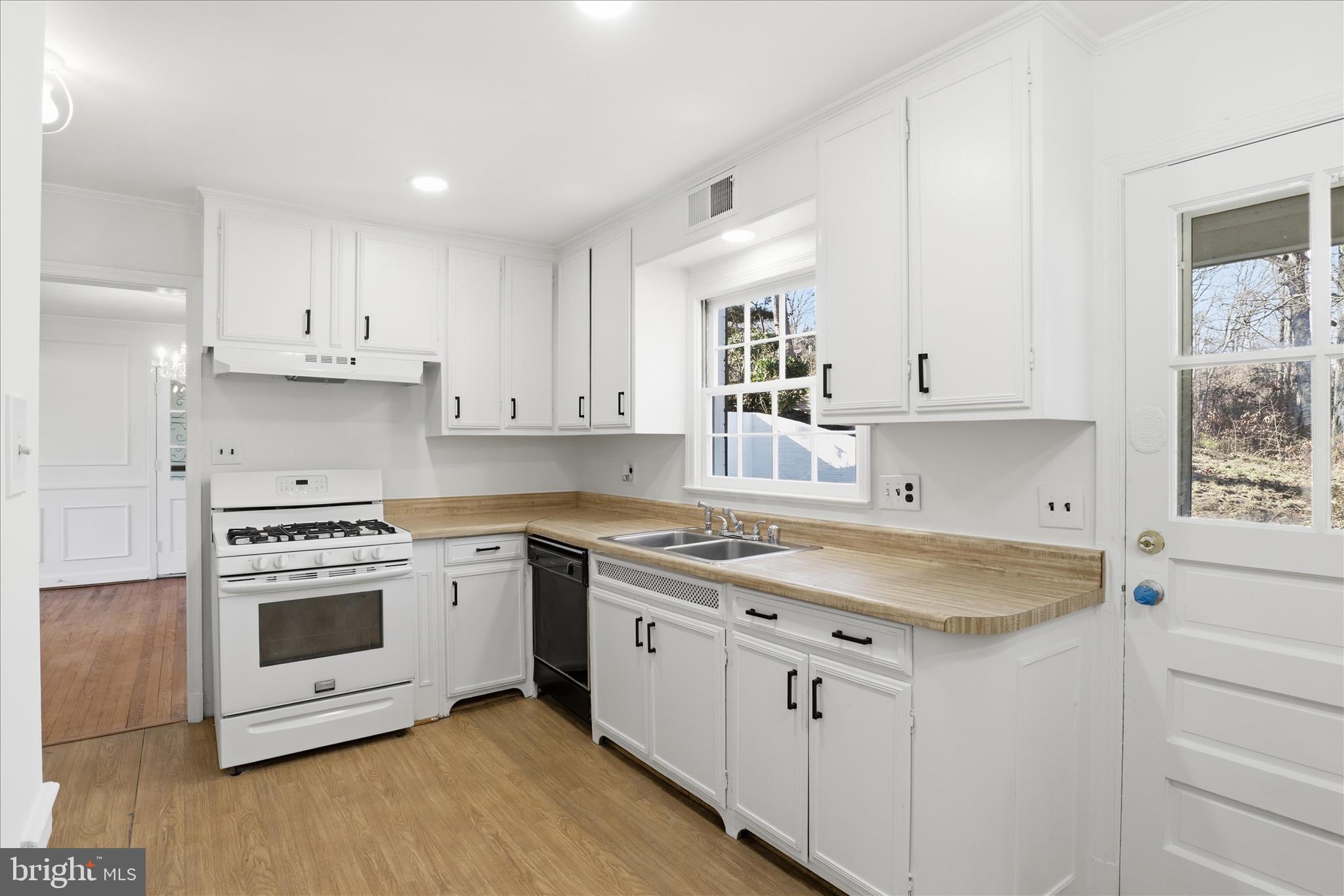 3701 Pine Brook Road Alexandria, VA 22310 - Photo 12 of 78 a kitchen with granite countertop white cabinets and white appliances