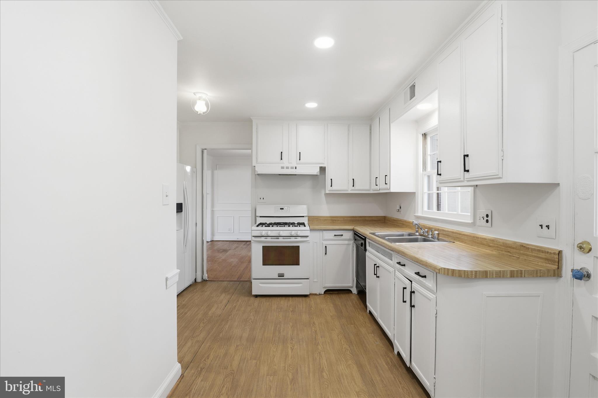 3701 Pine Brook Road Alexandria, VA 22310 - Photo 13 of 78 a kitchen with a sink stove and cabinets