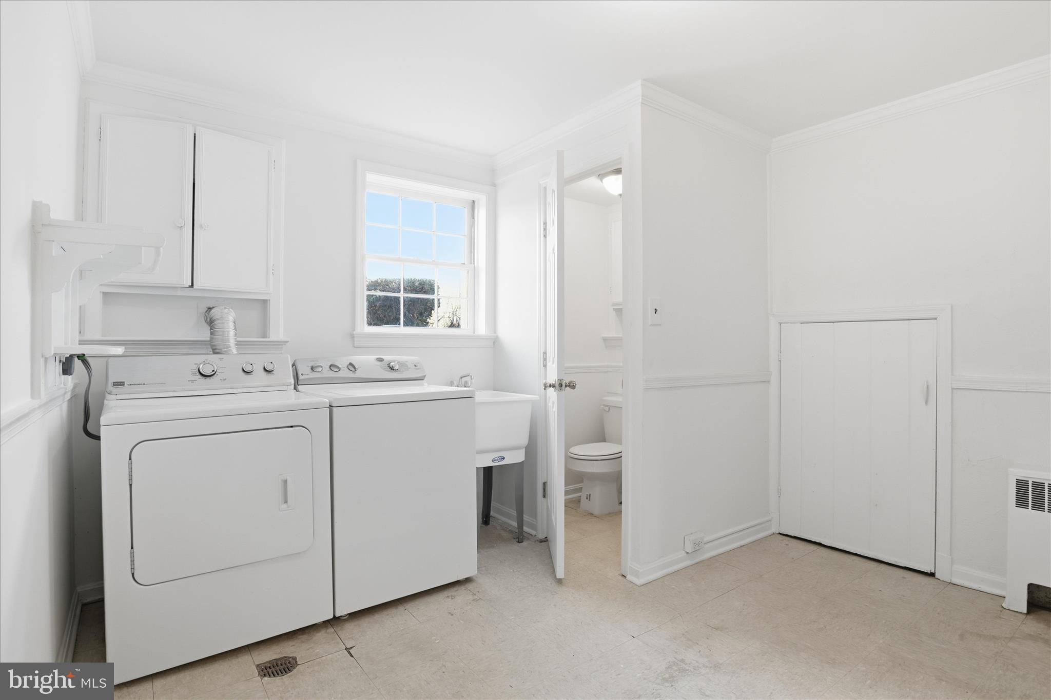 3701 Pine Brook Road Alexandria, VA 22310 - Photo 45 of 78 a utility room with cabinets washer and dryer