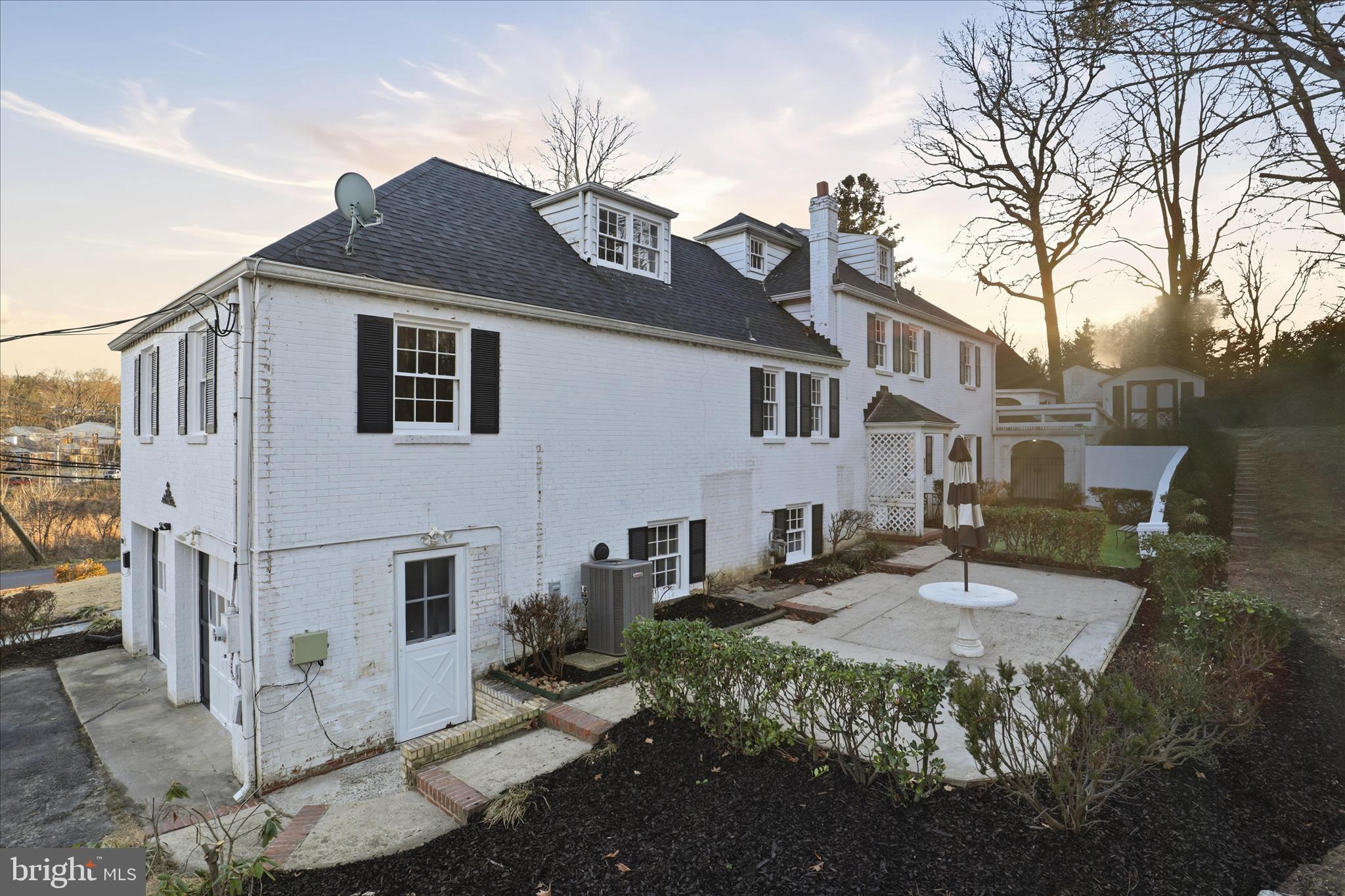 3701 Pine Brook Road Alexandria, VA 22310 - Photo 55 of 78 a view of a white house with large windows next to a road
