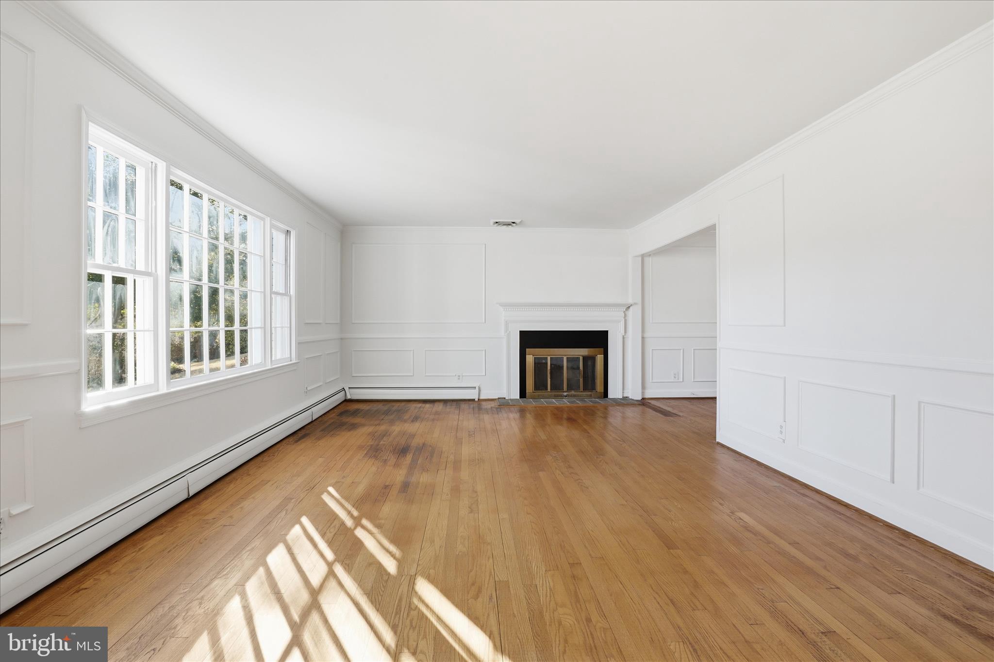 3701 Pine Brook Road Alexandria, VA 22310 - Photo 6 of 78 a view of empty room with wooden floor and fireplace