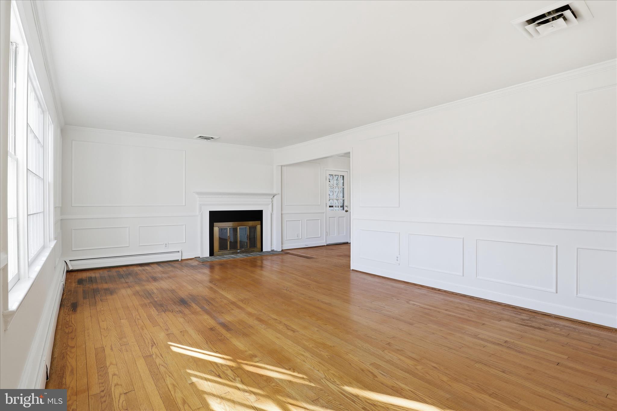 3701 Pine Brook Road Alexandria, VA 22310 - Photo 7 of 78 a view of empty room with wooden floor and fireplace