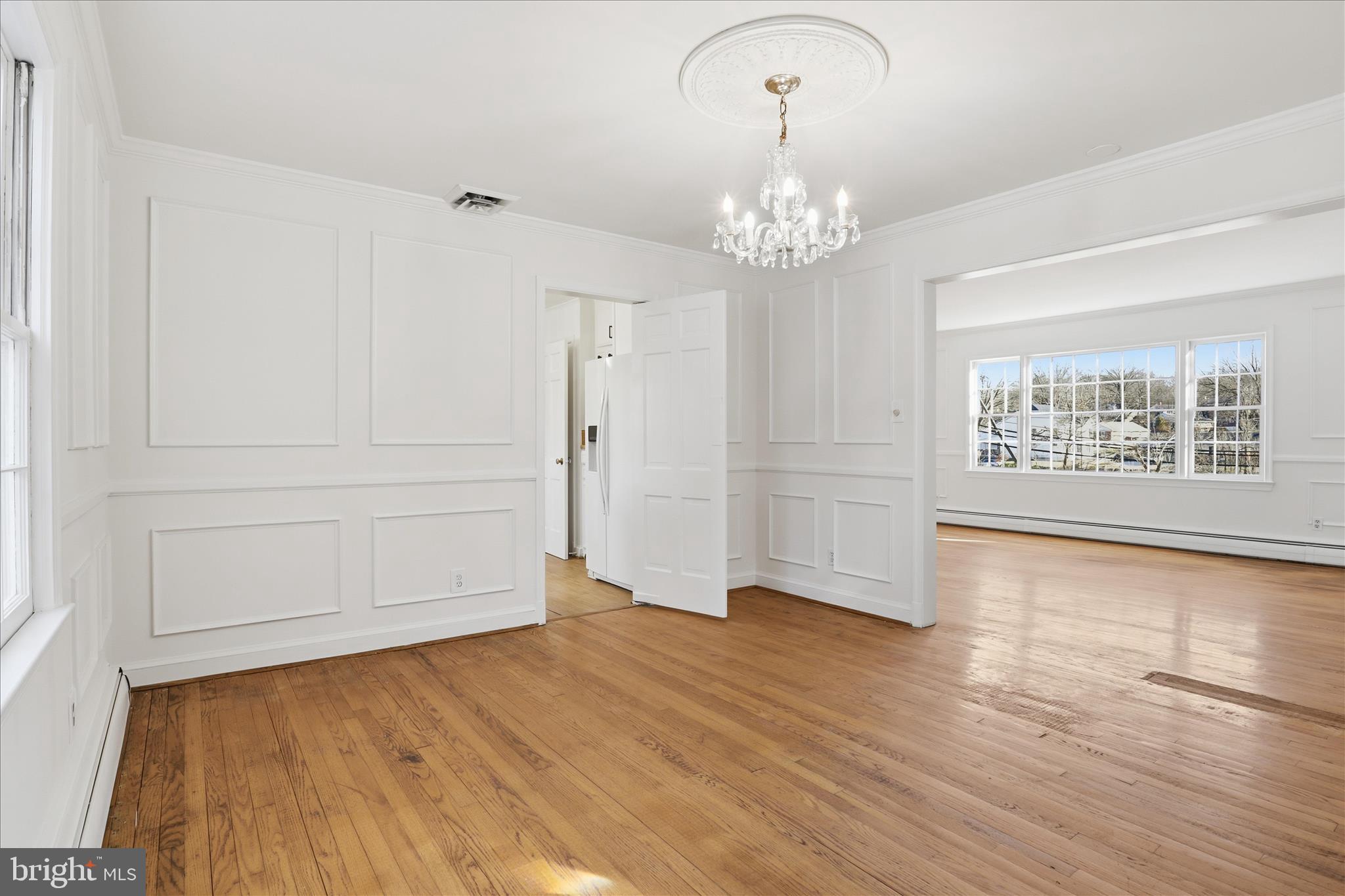 3701 Pine Brook Road Alexandria, VA 22310 - Photo 10 of 78 an empty room with wooden floor chandelier and windows