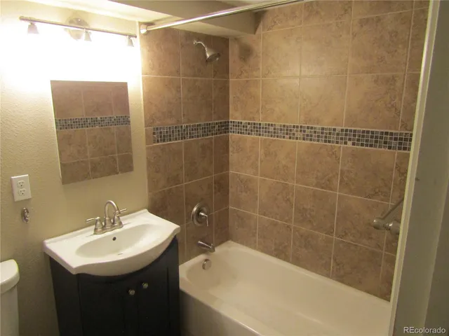 a bathroom with a sink shower and a bathtub