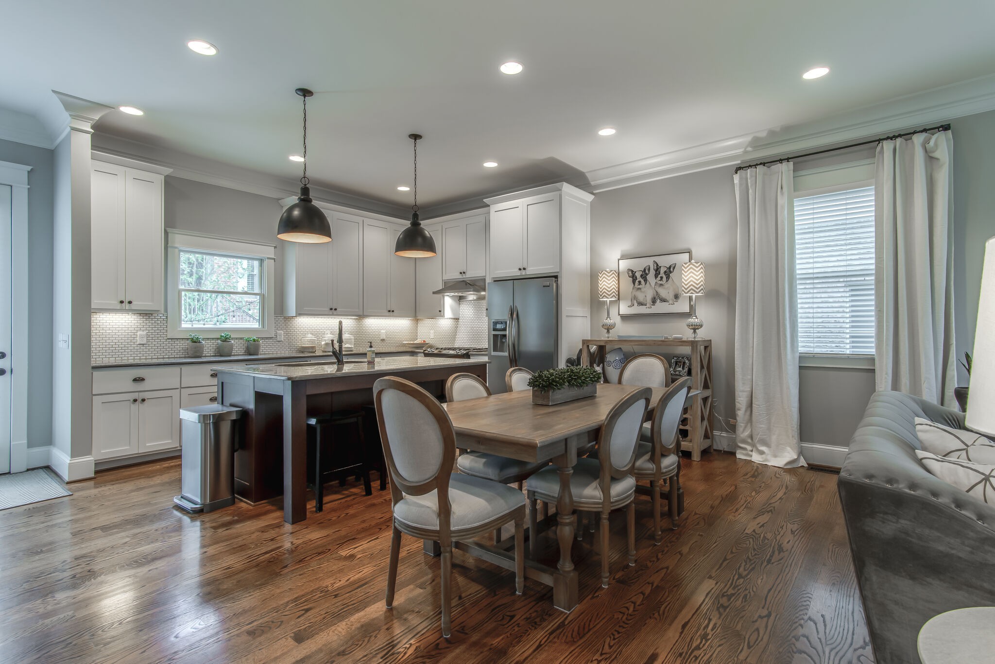 706 Crescent Road Nashville, TN 37205 - Photo 6 of 27 a dining room with stainless steel appliances kitchen island granite countertop a table chairs and a refrigerator
