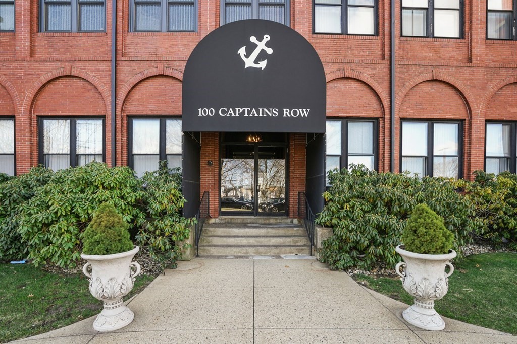 a front view of a building with potted plants
