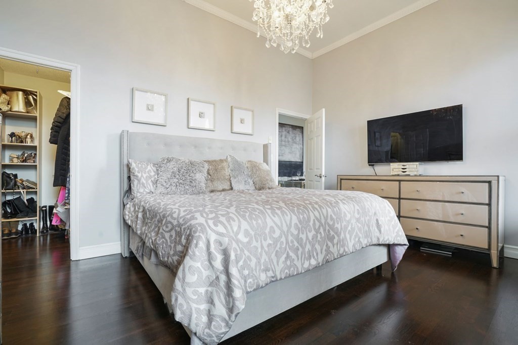 100 Captains Row, Unit 301 Chelsea, MA 02150 - Photo 12 of 23 a bedroom with a bed and a flat screen tv