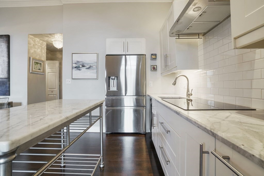 100 Captains Row, Unit 301 Chelsea, MA 02150 - Photo 21 of 23 a kitchen with stainless steel appliances a refrigerator and a sink