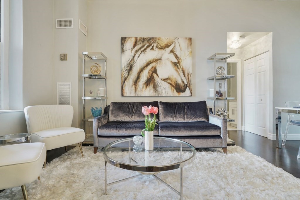 100 Captains Row, Unit 301 Chelsea, MA 02150 - Photo 8 of 23 a living room with furniture and a painting on the wall