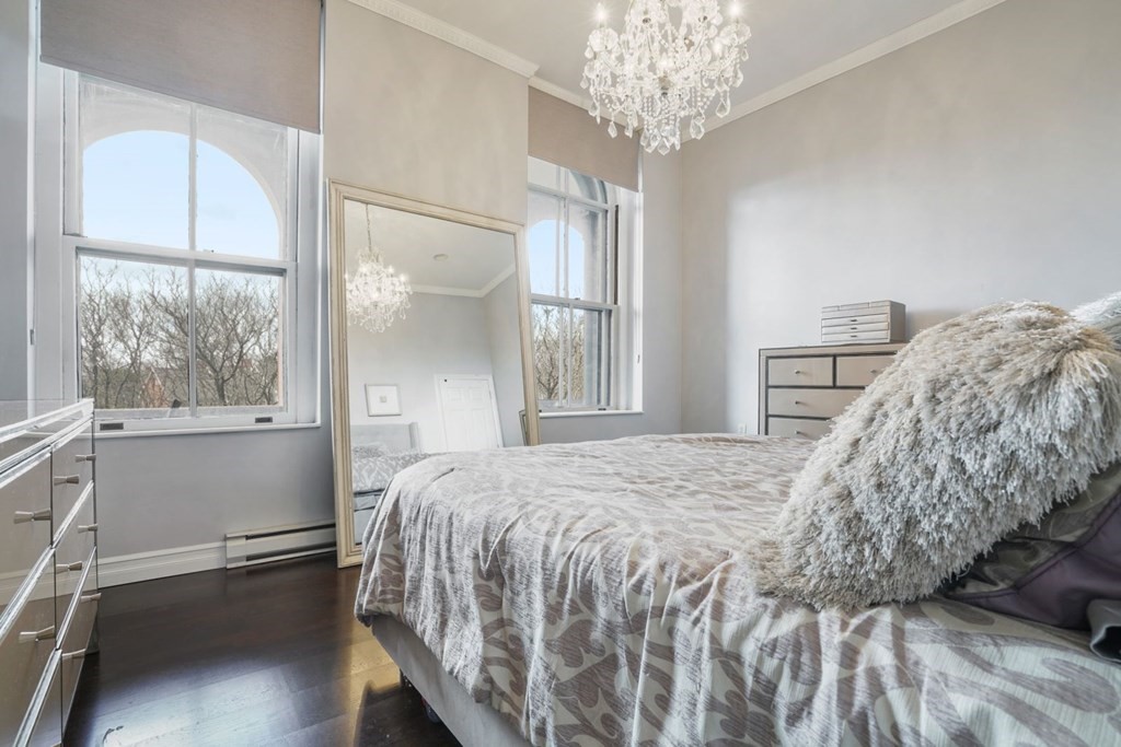 100 Captains Row, Unit 301 Chelsea, MA 02150 - Photo 10 of 23 a bedroom with a bed and a window