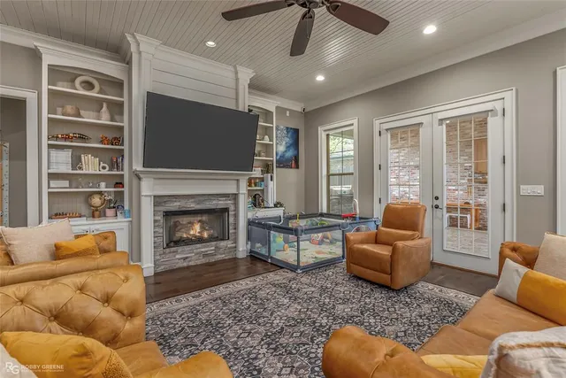 a living room with furniture a flat screen tv and a fireplace