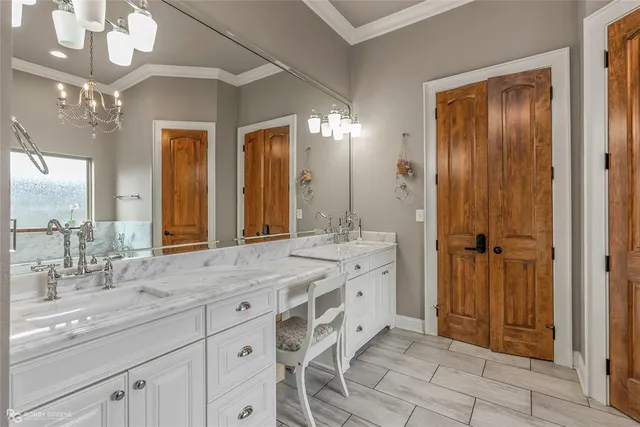a bathroom with a granite countertop sink mirror and double