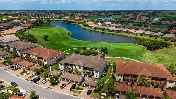 an aerial view of residential houses with outdoor space and river
