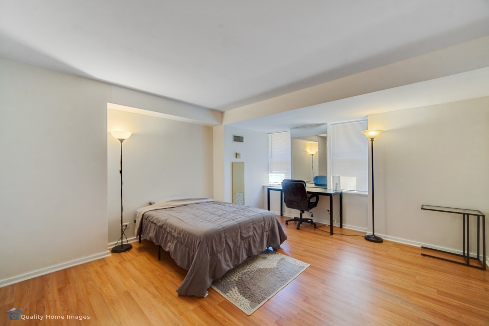 40 East 9th Street, Unit 405 Chicago, IL 60605 - Photo 12 of 18 a bedroom with a bed and wooden floor