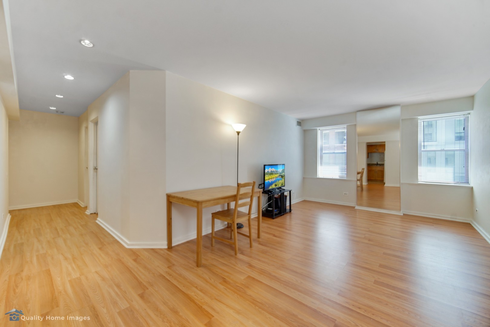 40 East 9th Street, Unit 405 Chicago, IL 60605 - Photo 4 of 18 a view of an empty room with wooden floor and a window