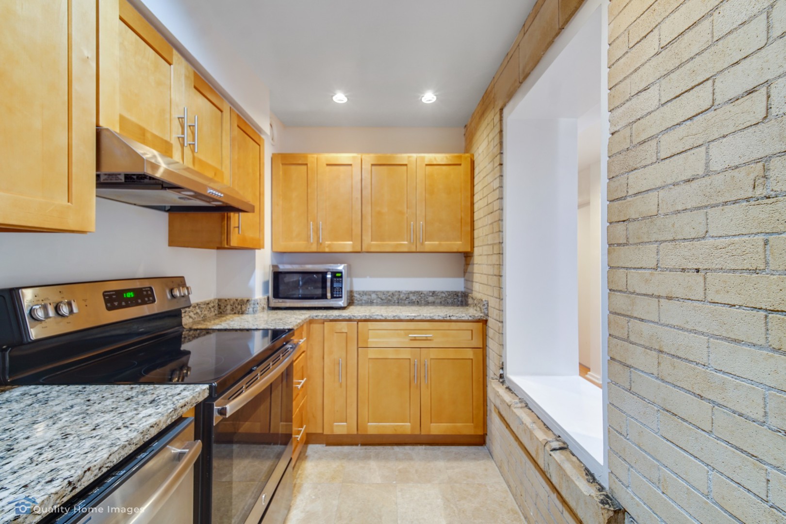 40 East 9th Street, Unit 405 Chicago, IL 60605 - Photo 6 of 18 a kitchen with stainless steel appliances granite countertop a sink and a stove