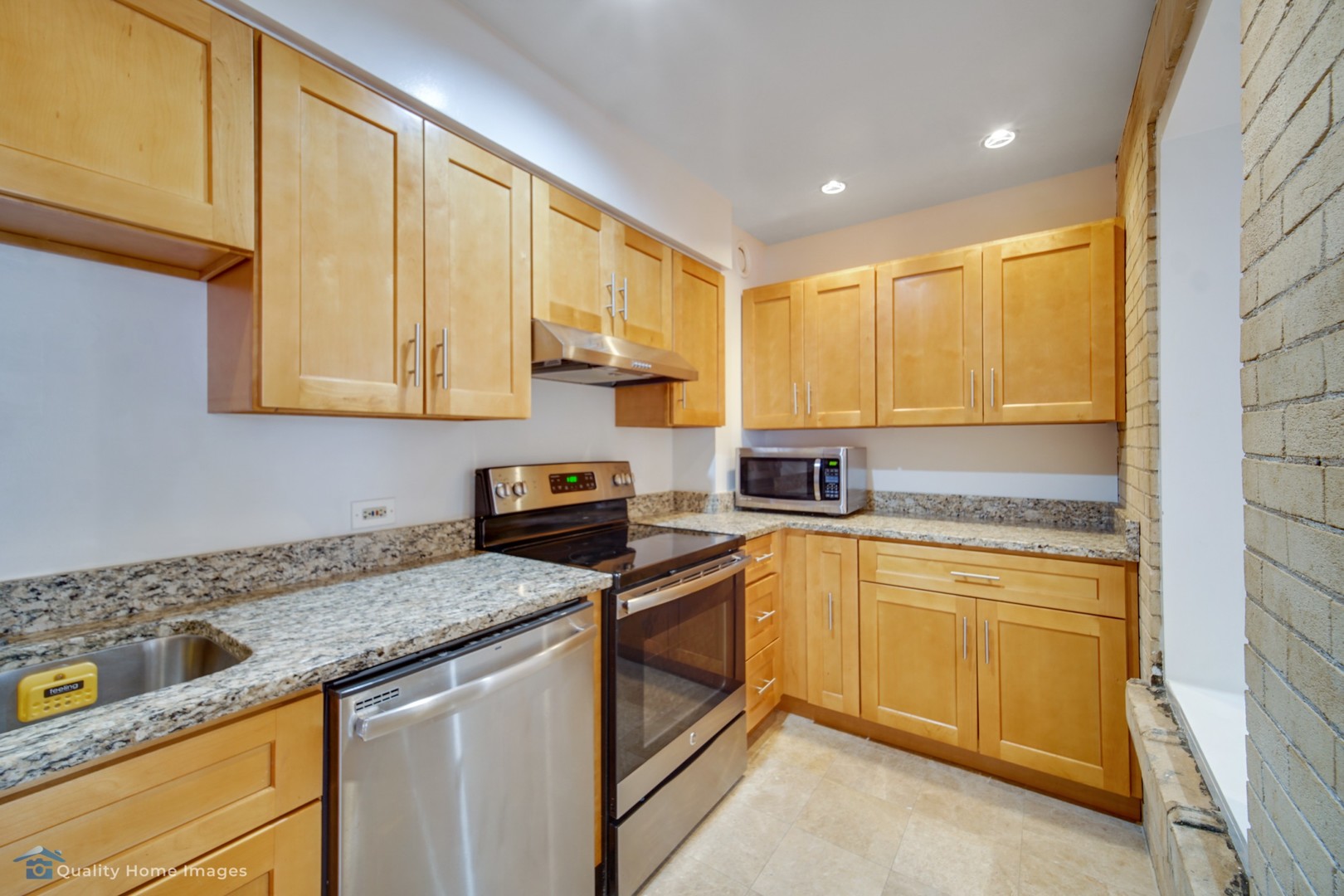 40 East 9th Street, Unit 405 Chicago, IL 60605 - Photo 9 of 18 a kitchen with stainless steel appliances granite countertop a sink stove and cabinets