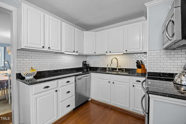 a kitchen with stainless steel appliances granite countertop a stove and a microwave